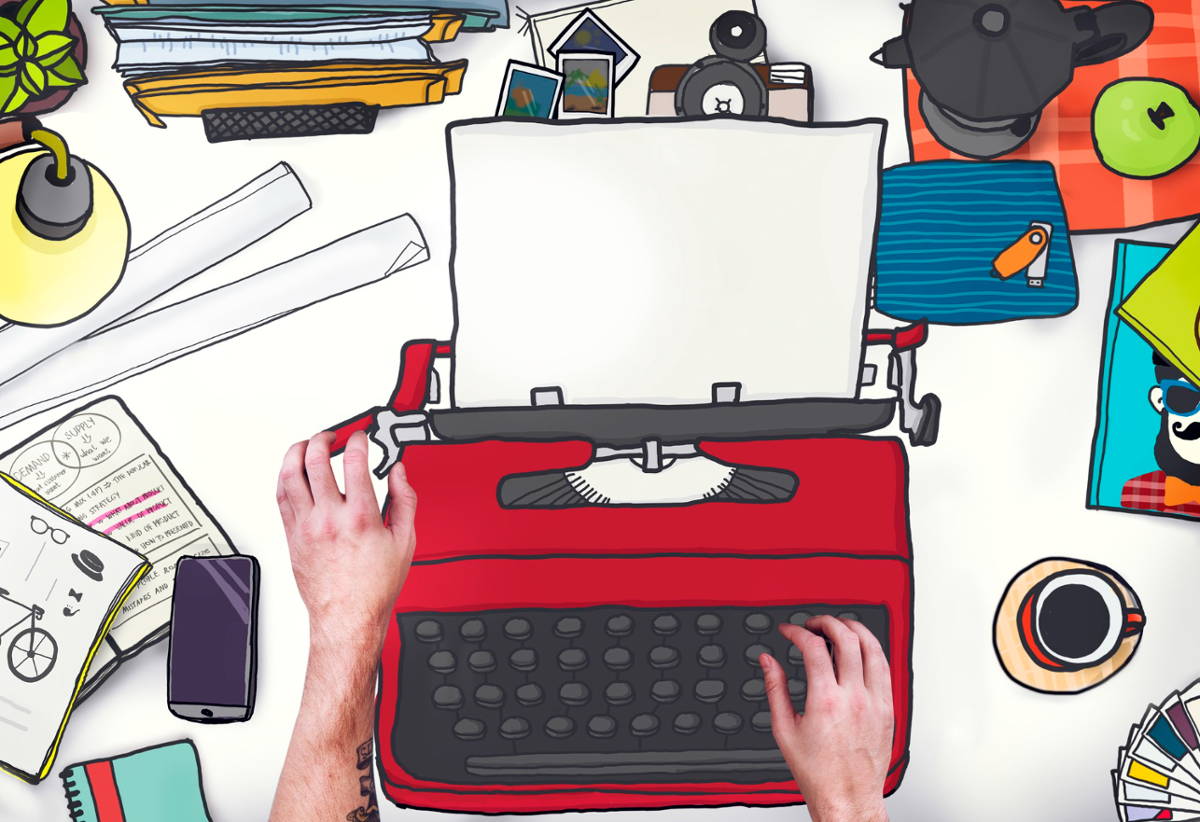 Máquina de escribir roja con distintos elementos de trabajo con pen drive, café, móvil,papeles...