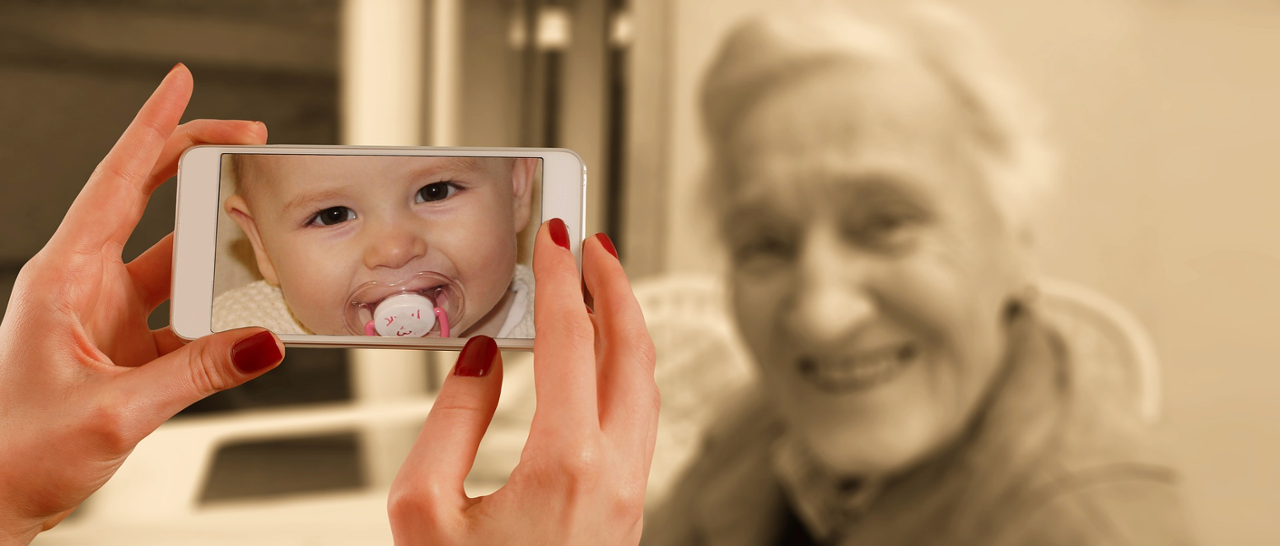 Móvil haciendo una foto a una anciiana donde se ve un bebé